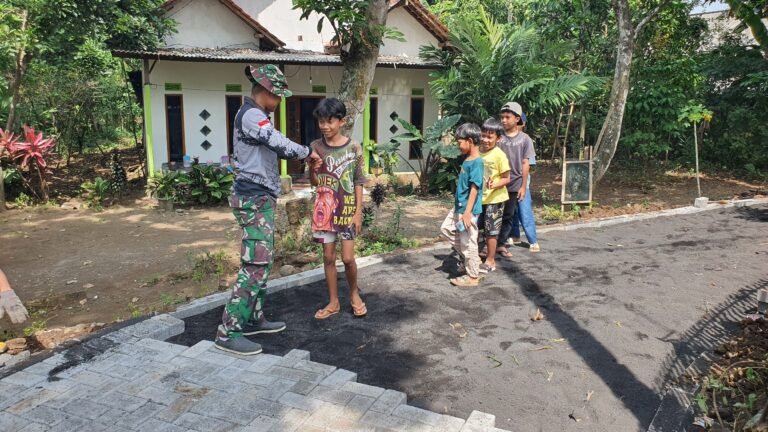 Anak-Anak Antusias Saksikan Pemasangan Paving TMMD Ke-128 di Desa Brabe. 